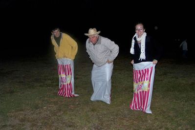 Charlie, Pastor Larry, & Jessica--sack race
